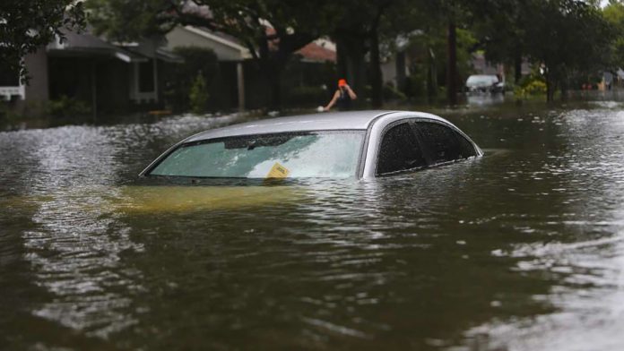 Deidre Merryweather , seen here in the background, was cited by the city of Houston for abandoning her car in the middle of the street.